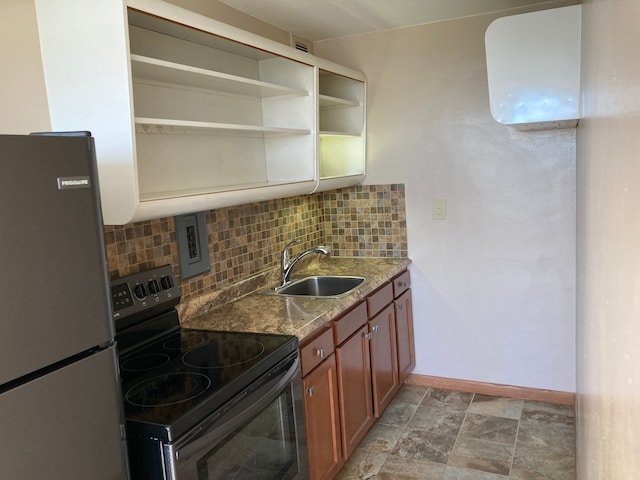 kitchen featuring tasteful backsplash, light stone countertops, sink, and stainless steel appliances