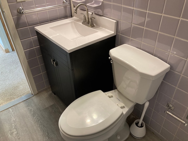 bathroom with toilet and tile walls