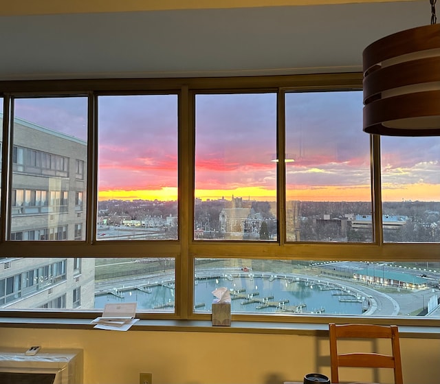 unfurnished sunroom featuring a water view