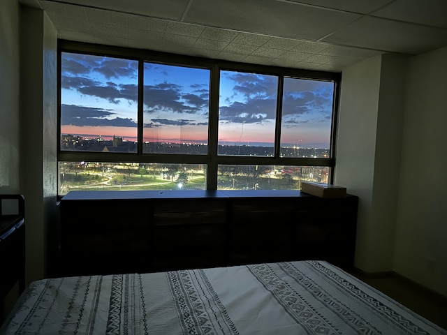 unfurnished bedroom featuring a drop ceiling