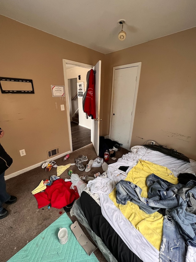 bedroom featuring dark carpet
