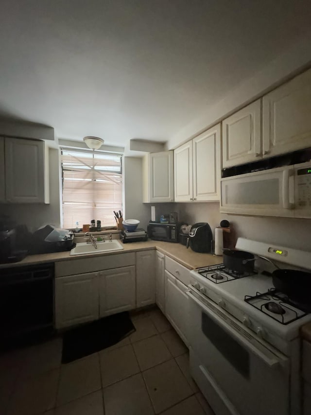 20920/2 Moross Rd, Grosse Pointe, MI 48236 - kitchen with black appliances, a sink, light tile patterned flooring, white cabinetry, and light countertops