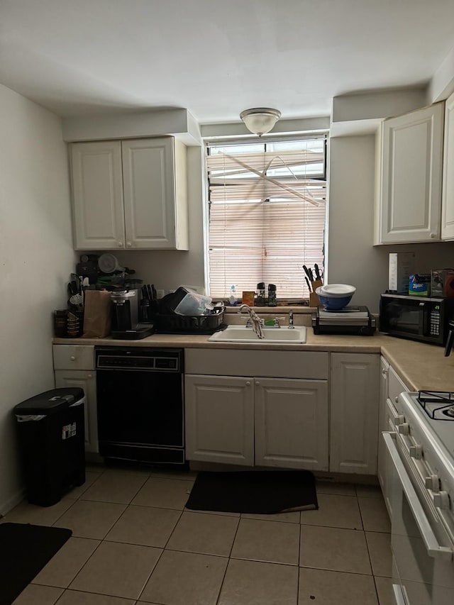 kitchen with light tile patterned floors, sink, white cabinetry, and black appliances