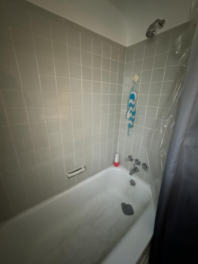 bathroom with shower / bathtub combination with curtain