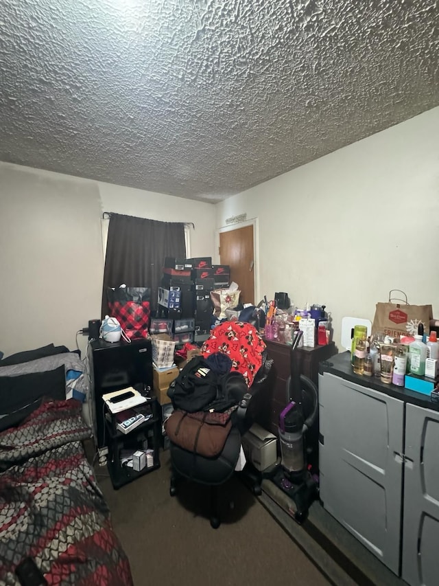 bedroom with carpet and a textured ceiling