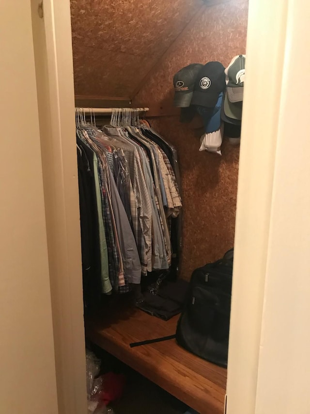 walk in closet featuring lofted ceiling