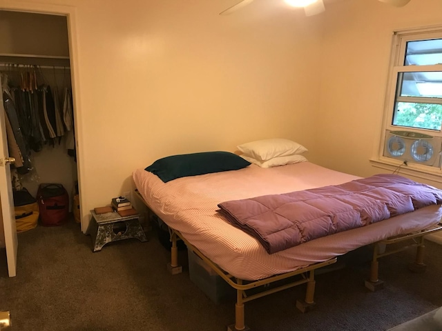 carpeted bedroom featuring ceiling fan and a closet