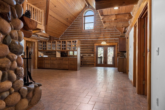 unfurnished living room featuring wooden ceiling, high vaulted ceiling, and a healthy amount of sunlight