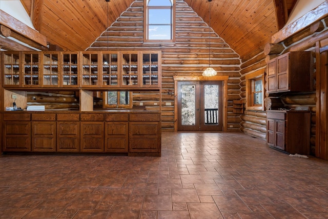 kitchen with wood ceiling, rustic walls, high vaulted ceiling, and a healthy amount of sunlight