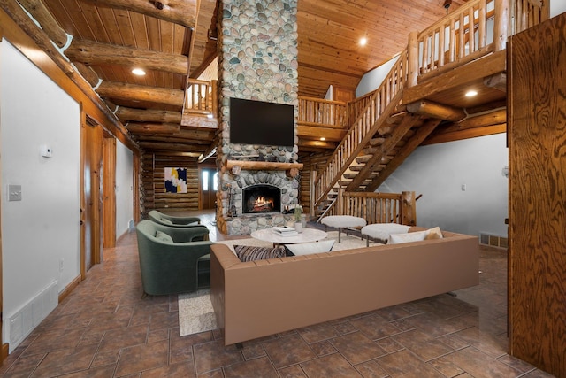 living room featuring a fireplace, high vaulted ceiling, rustic walls, and wood ceiling