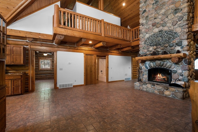 living room with wooden ceiling, high vaulted ceiling, ceiling fan, and a stone fireplace