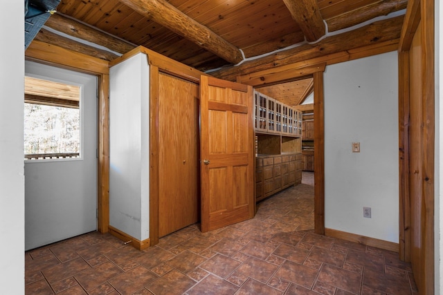 hallway featuring beamed ceiling and wood ceiling