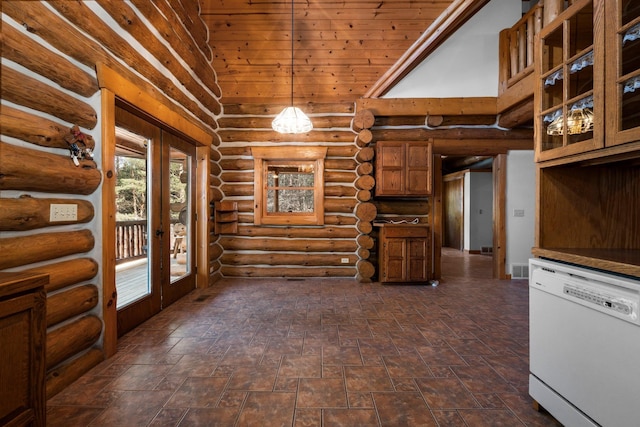 kitchen with french doors, a towering ceiling, rustic walls, white dishwasher, and decorative light fixtures