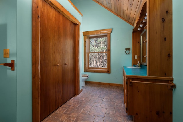 bathroom featuring toilet, vanity, vaulted ceiling, and wooden ceiling