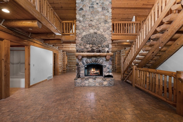 unfurnished living room featuring rustic walls, wooden ceiling, and a fireplace