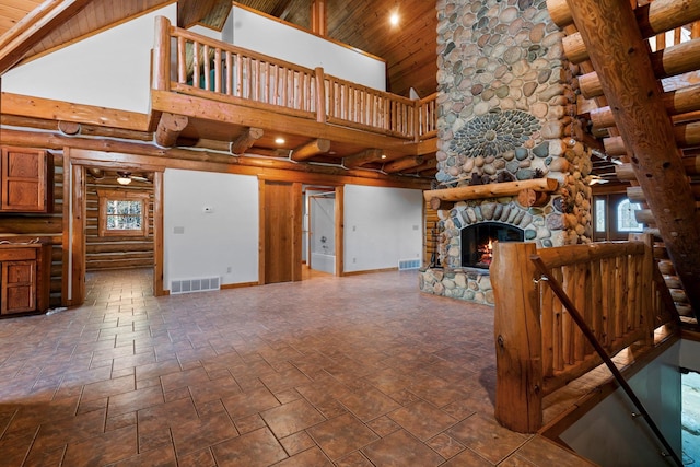 unfurnished living room with high vaulted ceiling, a stone fireplace, and wood ceiling