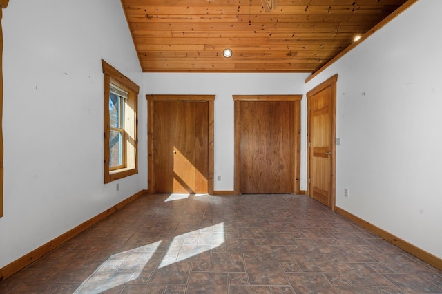 unfurnished bedroom featuring vaulted ceiling and wood ceiling