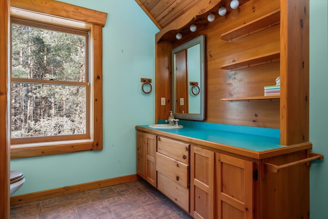 bathroom with vanity, wood ceiling, vaulted ceiling, and toilet