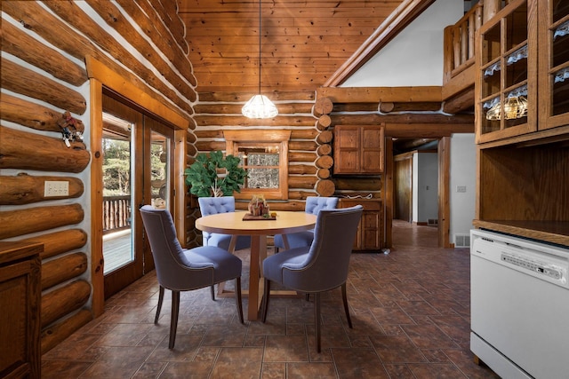 dining area with a towering ceiling, rustic walls, and wooden ceiling