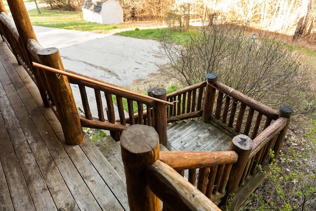 wooden terrace with a storage shed