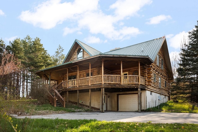 rear view of house featuring a garage