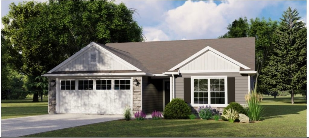 view of front of property featuring a front yard and a garage