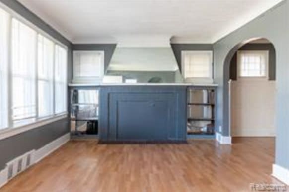 unfurnished living room featuring hardwood / wood-style floors