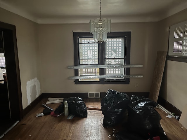 dining room featuring hardwood / wood-style flooring and an inviting chandelier