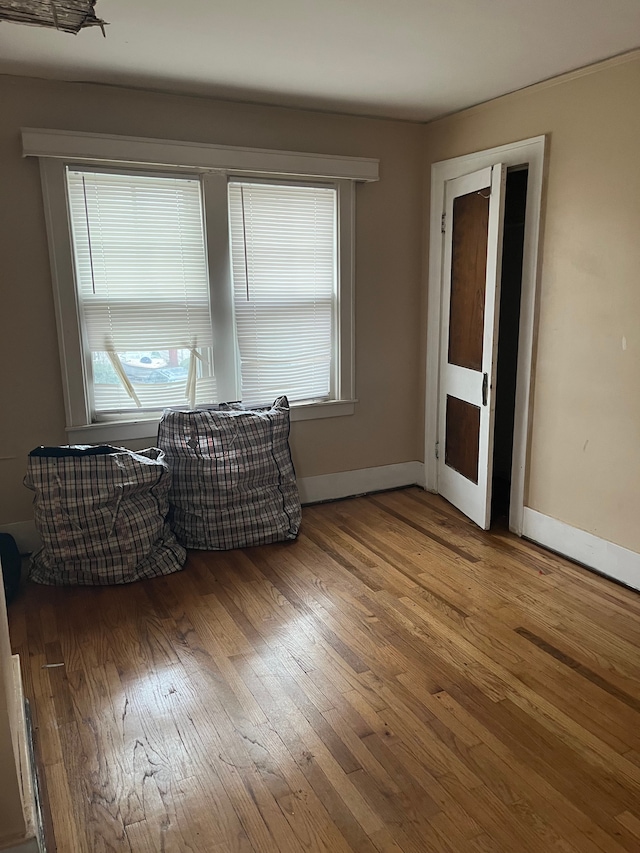 unfurnished room with wood-type flooring