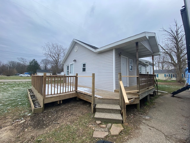 view of property exterior featuring a wooden deck