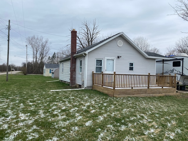 back of house with a yard and a wooden deck