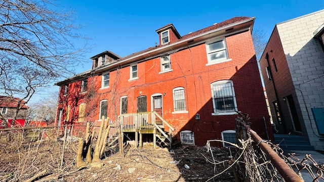 back of house with central AC