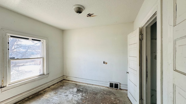 spare room with a textured ceiling