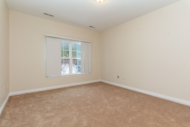 unfurnished room with light colored carpet