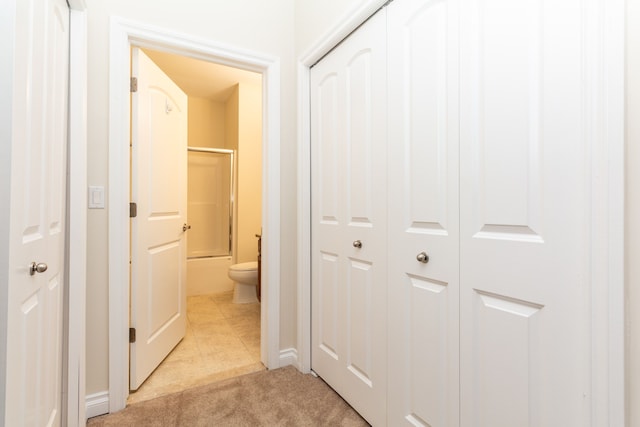 corridor featuring light tile patterned floors