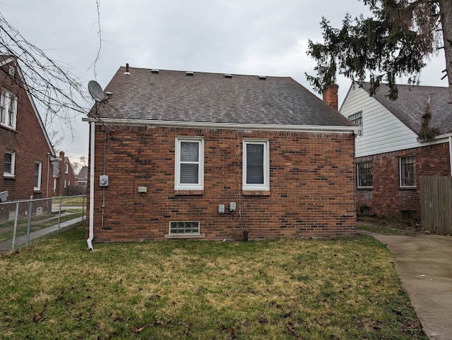 rear view of property with a lawn