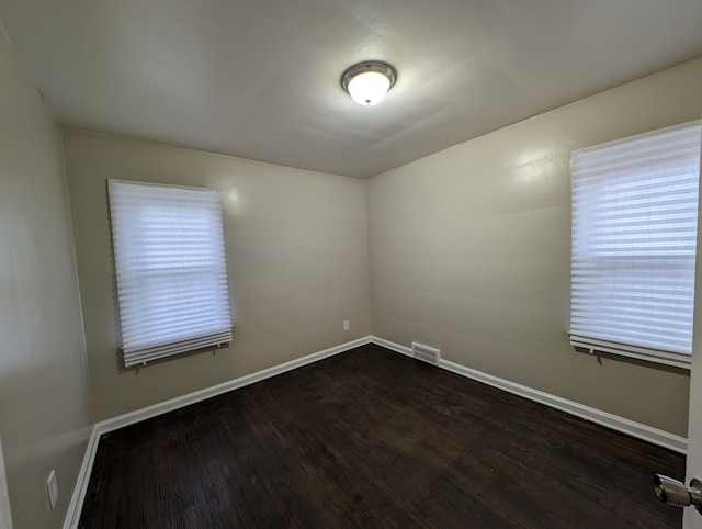 unfurnished room featuring dark hardwood / wood-style floors