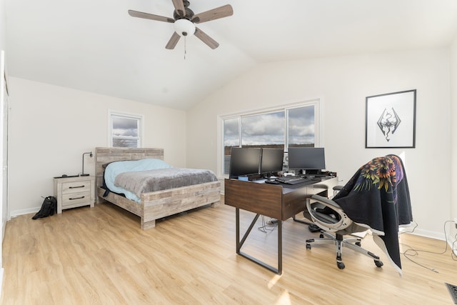 bedroom with ceiling fan, vaulted ceiling, and light hardwood / wood-style flooring