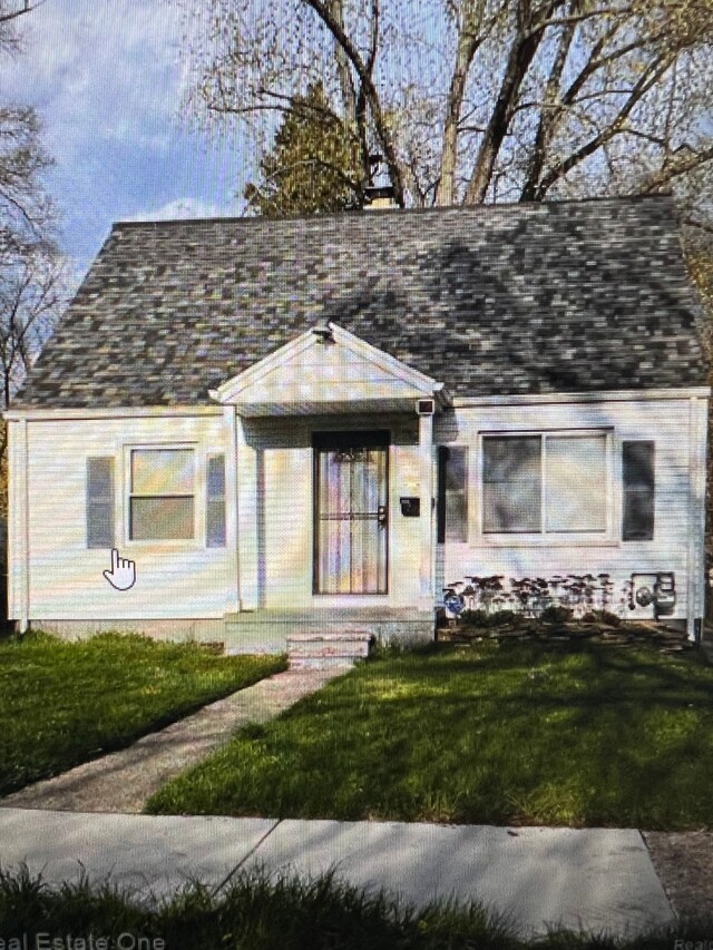 15920 Bramell St, Detroit, MI 48223 - view of front of house with roof with shingles and a front lawn