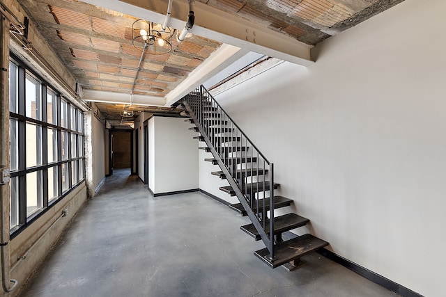 basement with a notable chandelier