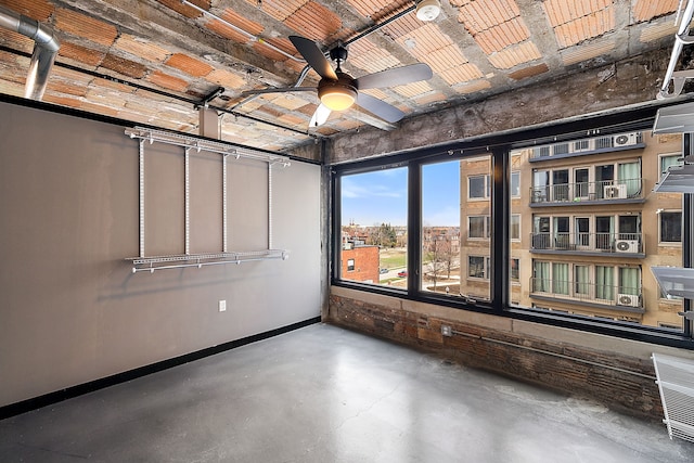 unfurnished room with concrete flooring and ceiling fan