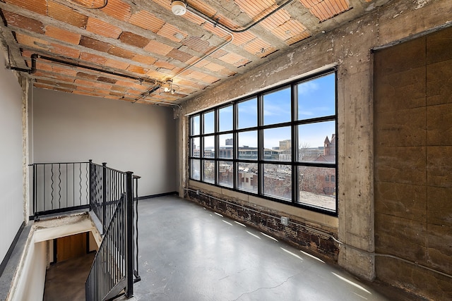 unfurnished room with concrete flooring