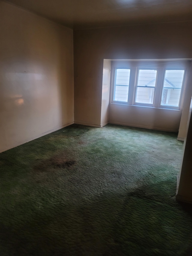 empty room featuring dark colored carpet