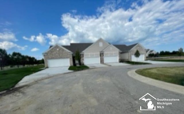 view of front of property with a garage and driveway