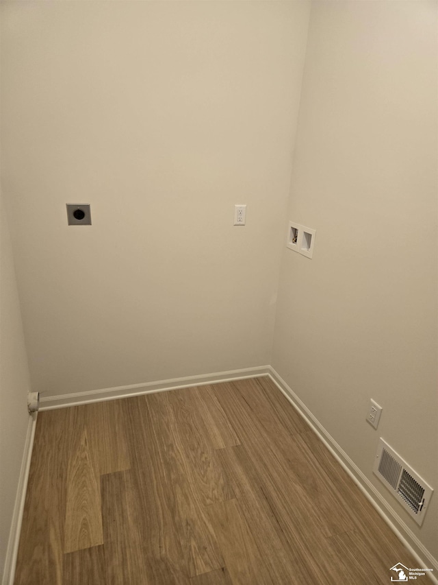 807 Plum Village Dr, Monroe, MI 48161 - laundry room featuring hookup for a washing machine, electric dryer hookup, wood finished floors, and baseboards