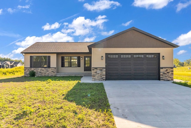 view of front of property with a front yard and a garage