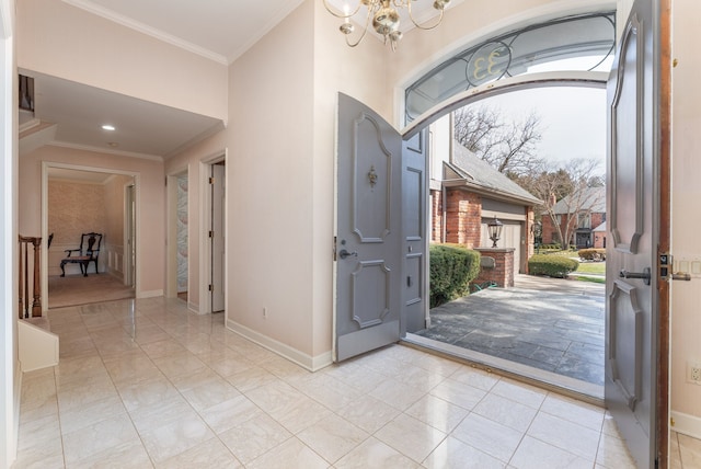 entrance foyer featuring crown molding and a chandelier