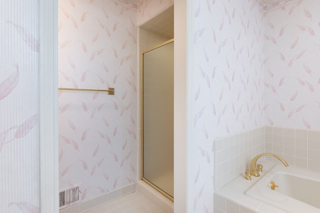 bathroom featuring tile patterned flooring and independent shower and bath