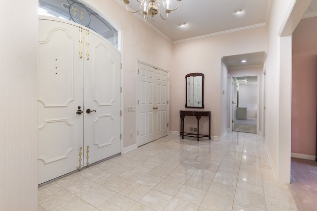 entrance foyer featuring ornamental molding and a chandelier