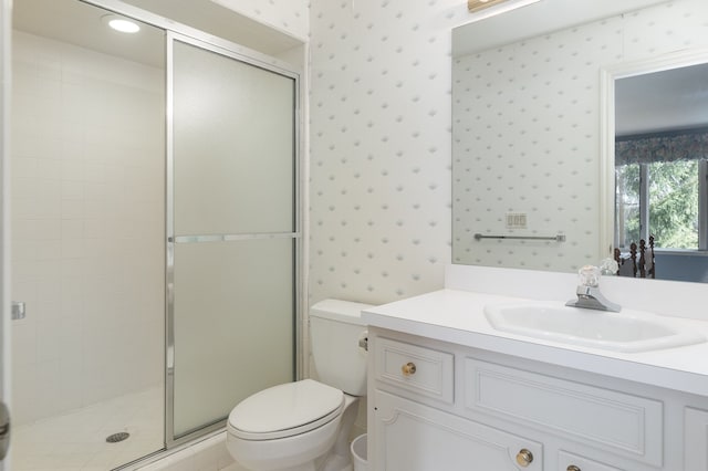 bathroom with vanity, toilet, and an enclosed shower